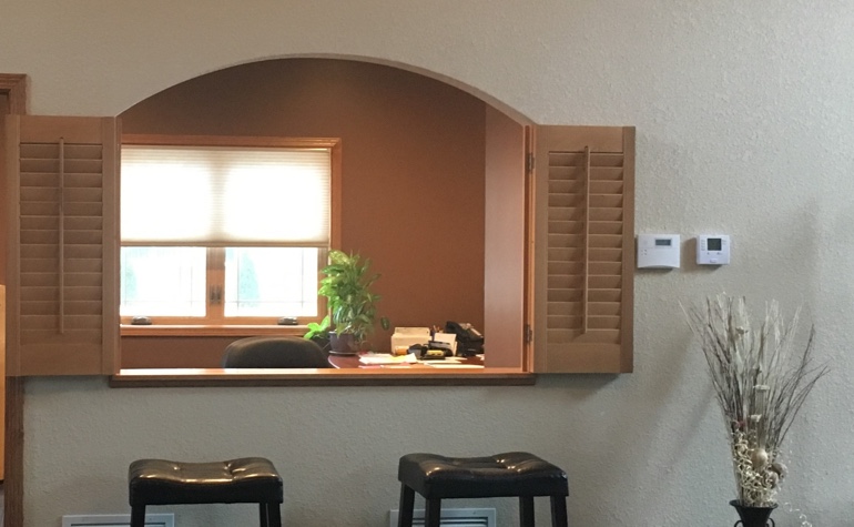 Wood shutters framing out a room's passthrough